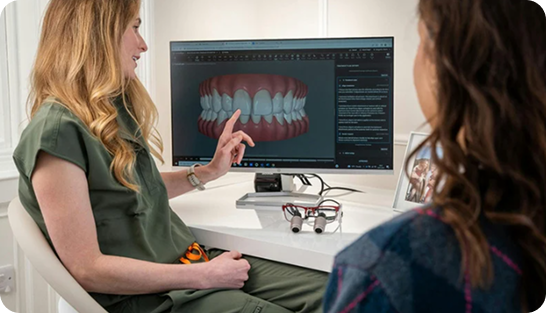 Dentist reviewing 3D digital scan for Invisalign Aligners with patient, showing predictable teeth straightening results.