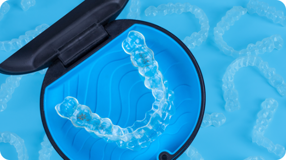Clear Invisalign Aligners in the blue storage case, product shot for Tellapur Invisalign Center.
